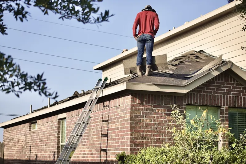 Professional roofer working on a residential roof in Kimball